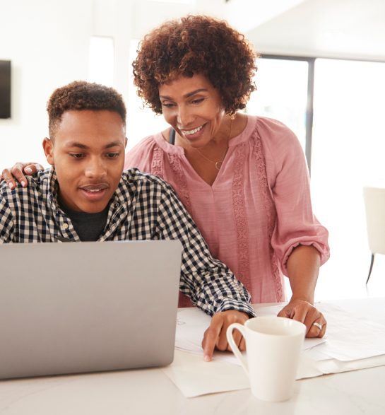 Business owner reviewing growth on a laptop